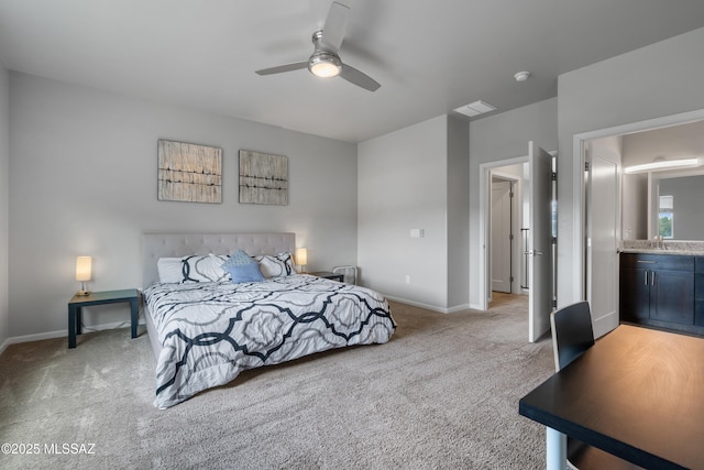 156 E Stone Ct, Tucson, AZ 85705 - bedroom with light carpet, baseboards, a sink, ceiling fan, and connected bathroom