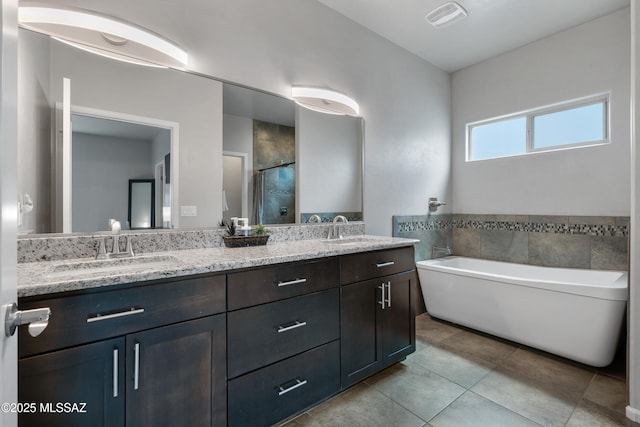 156 E Stone Ct, Tucson, AZ 85705 - full bath featuring tile patterned floors, double vanity, a stall shower, and a freestanding tub