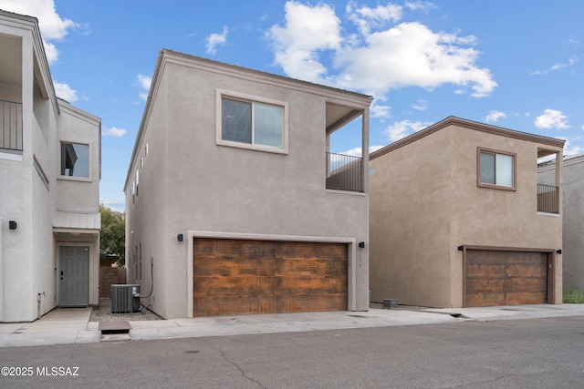 156 E Stone Ct, Tucson, AZ 85705 - view of front facade with stucco siding, an attached garage, and a balcony