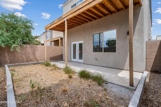 156 E Stone Ct, Tucson, AZ 85705 - rear view of house featuring stucco siding, fence, french doors, and a patio area