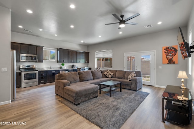 156 E Stone Ct, Tucson, AZ 85705 - living room featuring recessed lighting, light wood finished floors, french doors, ceiling fan, and baseboards