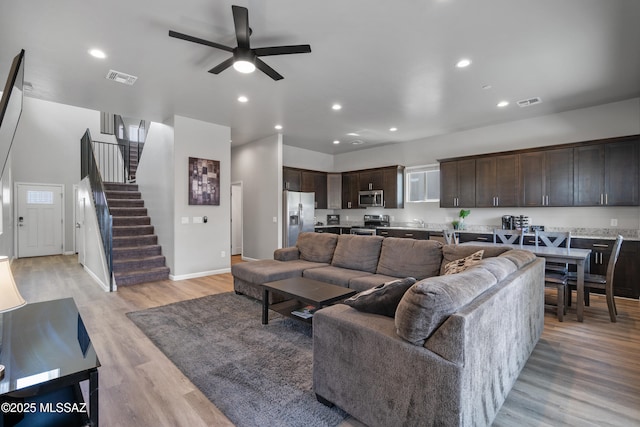 156 E Stone Ct, Tucson, AZ 85705 - living area featuring stairway, ceiling fan, light wood-type flooring, recessed lighting, and baseboards
