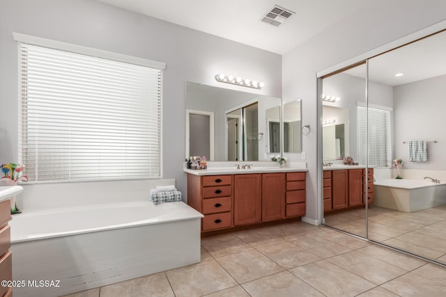 1933 E Lafayette Ave, Gilbert, AZ 85298 - full bathroom featuring a sink, two vanities, a bath, visible vents, and tile patterned flooring