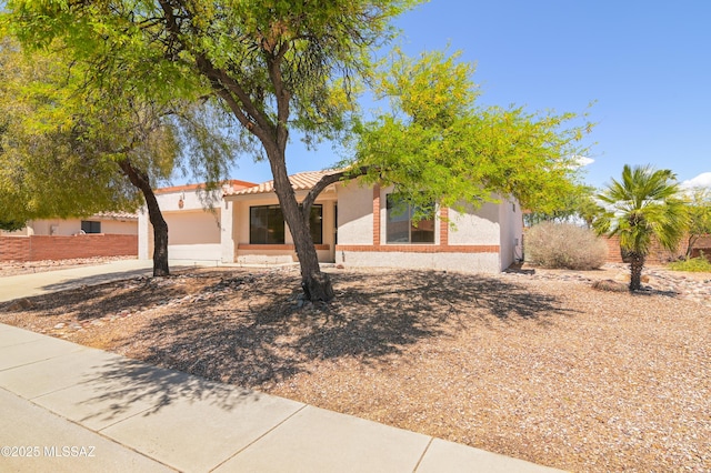 view of front of home featuring stucco siding and driveway