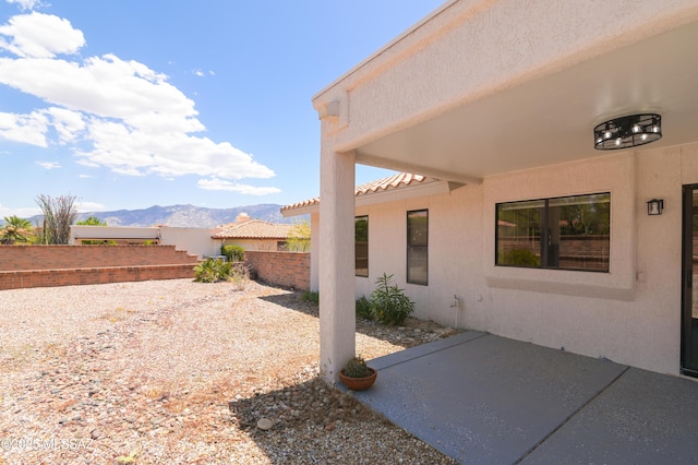 exterior space featuring a mountain view and fence
