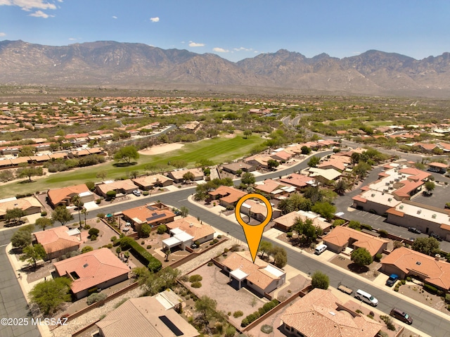 drone / aerial view with a residential view, a mountain view, and view of golf course