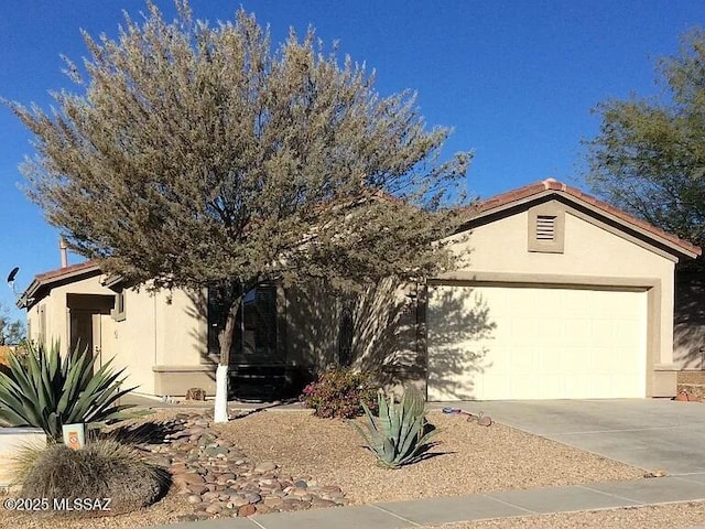 12445 N Crimson Vista Dr, Marana, AZ 85658 - view of property hidden behind natural elements with stucco siding, driveway, and an attached garage