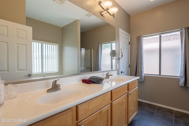12445 N Crimson Vista Dr, Marana, AZ 85658 - full bathroom featuring double vanity, tile patterned flooring, and baseboards