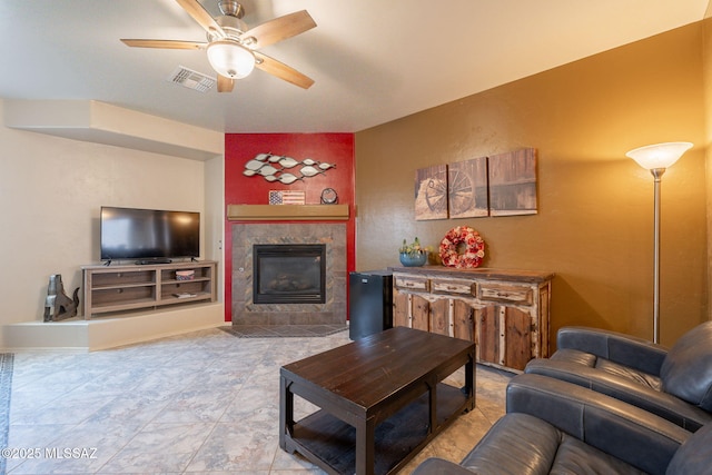 12445 N Crimson Vista Dr, Marana, AZ 85658 - tiled living room with ceiling fan and a tiled fireplace