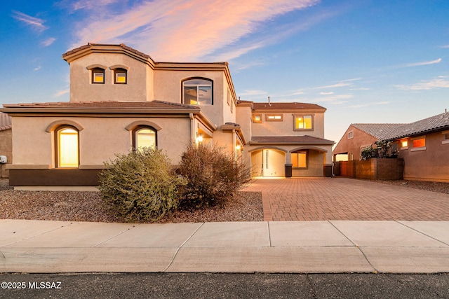 8695 W Cadwell Way, Marana, AZ 85653 - view of front of home with decorative driveway, stucco siding, fence, and covered porch