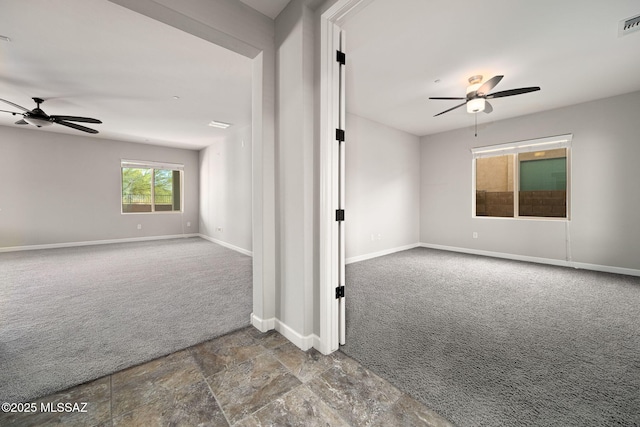 8695 W Cadwell Way, Marana, AZ 85653 - spare room featuring carpet flooring, ceiling fan, baseboards, and stone finish flooring