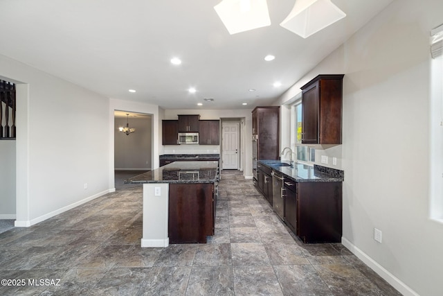 8695 W Cadwell Way, Marana, AZ 85653 - kitchen with appliances with stainless steel finishes, a sink, baseboards, dark stone countertops, and recessed lighting