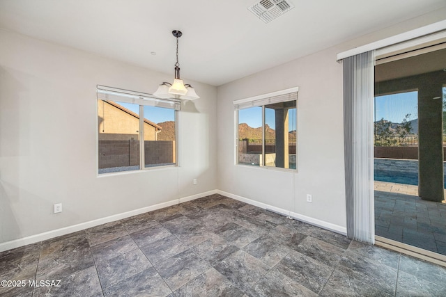 8695 W Cadwell Way, Marana, AZ 85653 - unfurnished dining area with baseboards, healthy amount of natural light, and stone finish floors