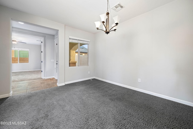 8695 W Cadwell Way, Marana, AZ 85653 - empty room featuring a chandelier, dark colored carpet, baseboards, and dark tile patterned flooring