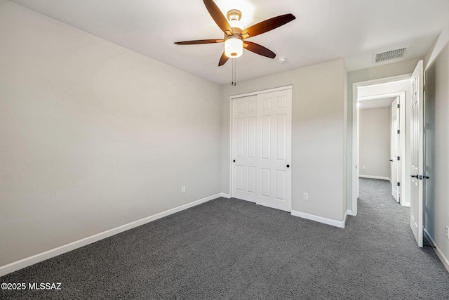 8695 W Cadwell Way, Marana, AZ 85653 - unfurnished bedroom featuring dark carpet, baseboards, and a ceiling fan