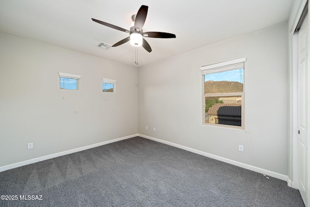 8695 W Cadwell Way, Marana, AZ 85653 - unfurnished room featuring dark carpet, ceiling fan, and baseboards