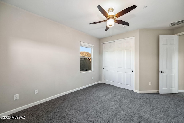 8695 W Cadwell Way, Marana, AZ 85653 - unfurnished bedroom with dark colored carpet, baseboards, a closet, and ceiling fan
