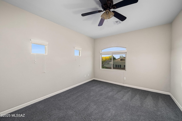 8695 W Cadwell Way, Marana, AZ 85653 - empty room with plenty of natural light, baseboards, and dark colored carpet