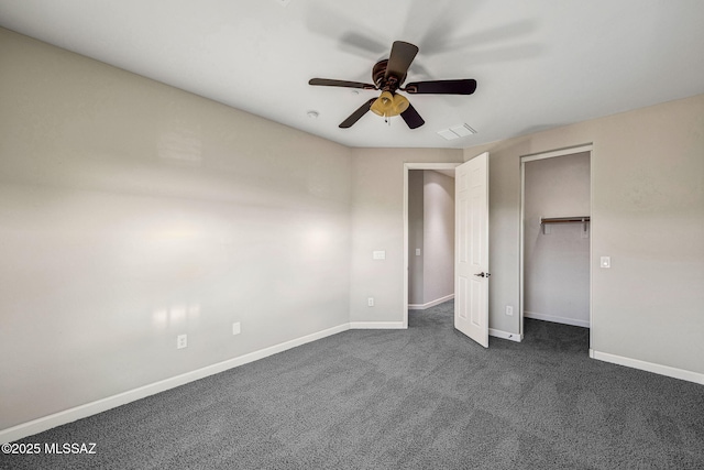 8695 W Cadwell Way, Marana, AZ 85653 - unfurnished bedroom with baseboards, dark carpet, a ceiling fan, and a closet