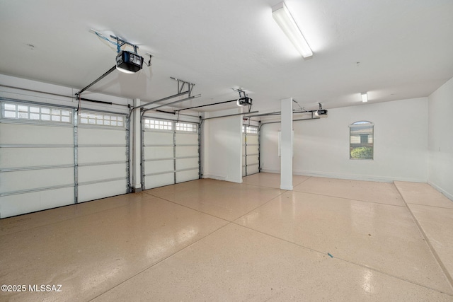 8695 W Cadwell Way, Marana, AZ 85653 - garage featuring a garage door opener and baseboards