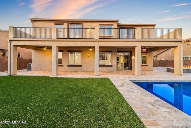 8695 W Cadwell Way, Marana, AZ 85653 - rear view of house featuring a balcony, a ceiling fan, a patio area, and an outdoor pool