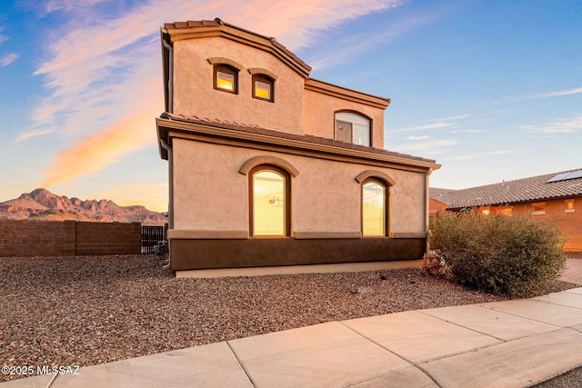 8695 W Cadwell Way, Marana, AZ 85653 - view of front of home with fence, stucco siding, and a mountain view
