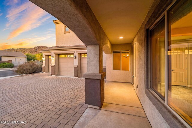 8695 W Cadwell Way, Marana, AZ 85653 - exterior space with stucco siding, an attached garage, and decorative driveway