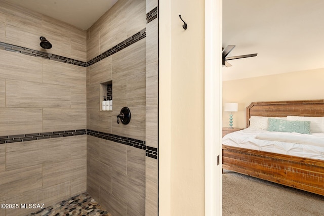 bathroom with ceiling fan and a tile shower
