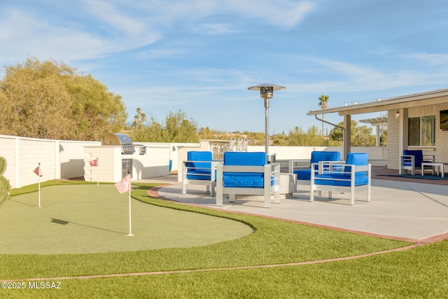 surrounding community featuring a patio area, exterior kitchen, and fence