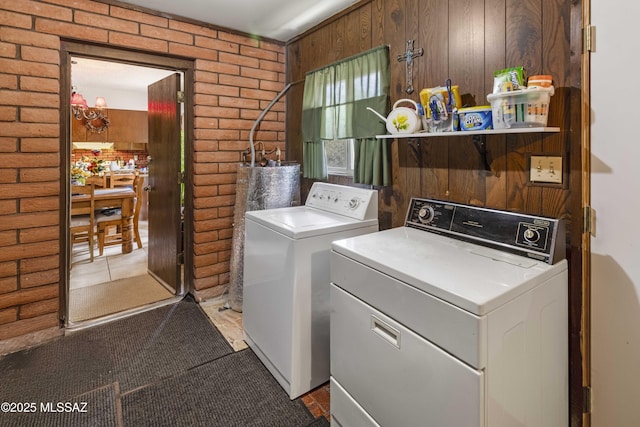 575 N Robles Rd, Oracle, AZ 85623 - washroom featuring independent washer and dryer, brick wall, water heater, and wooden walls