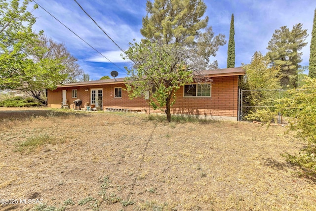 575 N Robles Rd, Oracle, AZ 85623 - rear view of house featuring french doors and brick siding