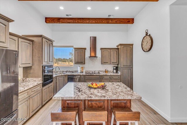 135 W Hawk Way, Amado, AZ 85645 - living room featuring light wood finished floors, beamed ceiling, ceiling fan with notable chandelier, and a healthy amount of sunlight