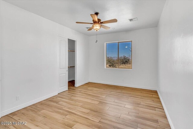 135 W Hawk Way, Amado, AZ 85645 - unfurnished room with baseboards, ceiling fan, visible vents, and wood finished floors