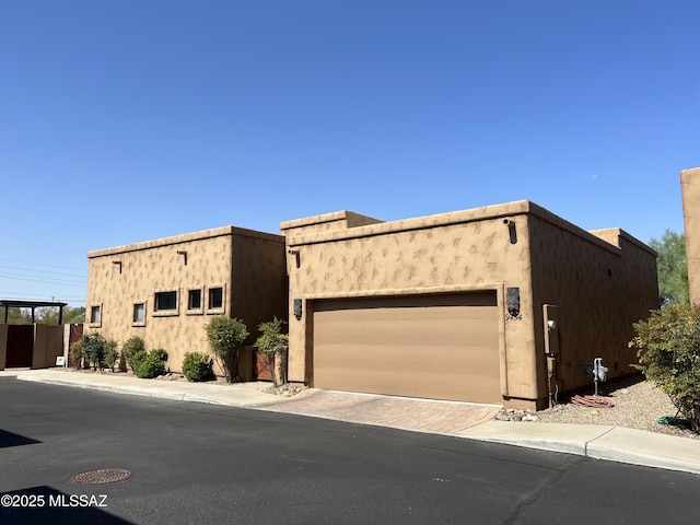 9454 E Lanterra Ct, Tucson, AZ 85710 - view of front of property with driveway, stucco siding, and a garage