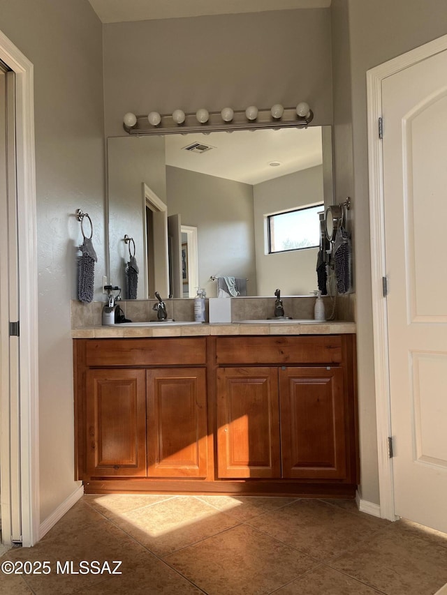 9454 E Lanterra Ct, Tucson, AZ 85710 - bathroom with double vanity, tile patterned floors, visible vents, and a sink
