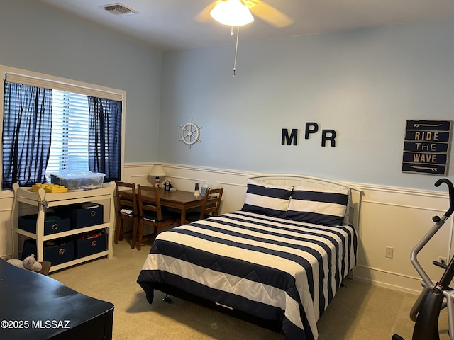 9454 E Lanterra Ct, Tucson, AZ 85710 - bedroom with a ceiling fan, wainscoting, visible vents, and carpet floors