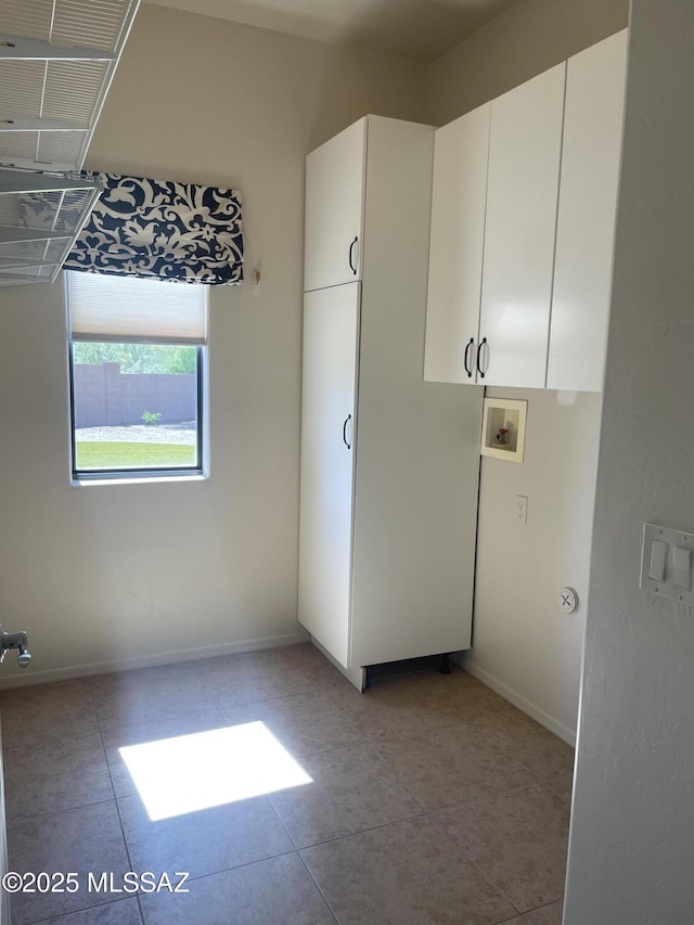 9454 E Lanterra Ct, Tucson, AZ 85710 - washroom with cabinet space, washer hookup, light tile patterned floors, and baseboards