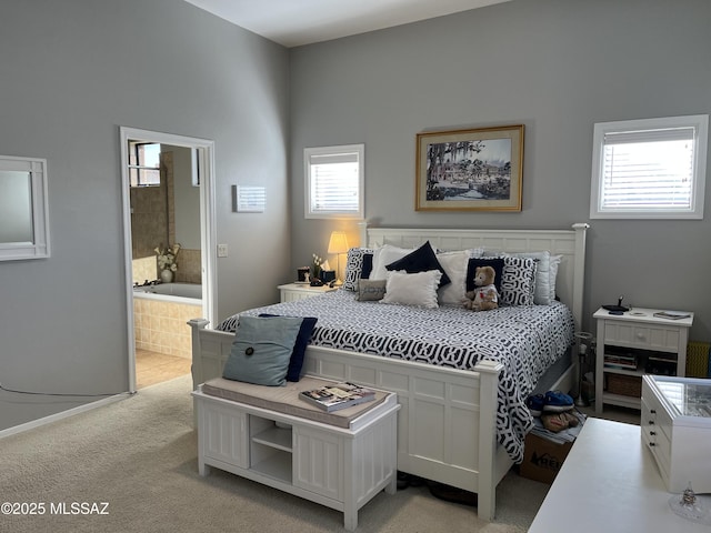 9454 E Lanterra Ct, Tucson, AZ 85710 - bedroom with baseboards, light carpet, and ensuite bath