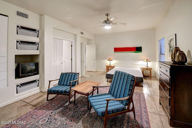 bedroom with light tile patterned floors, visible vents, baseboards, and ceiling fan