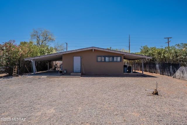 2220 E 35th St, Tucson, AZ 85713 - rear view of property with fence, a patio area, stucco siding, and a carport