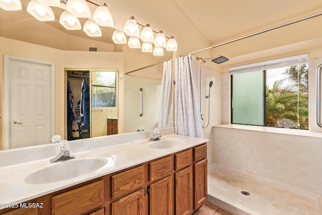 4755 W Lessing Ln, Tucson, AZ 85742 - full bathroom with lofted ceiling, curtained shower, plenty of natural light, double vanity, and tile patterned flooring