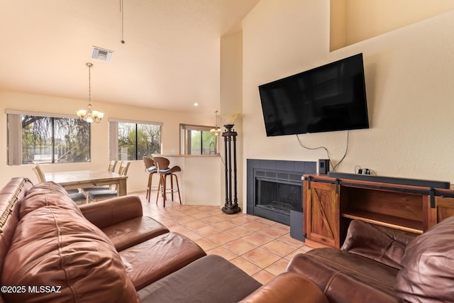 4755 W Lessing Ln, Tucson, AZ 85742 - living area with a chandelier, light tile patterned floors, a fireplace, high vaulted ceiling, and baseboards