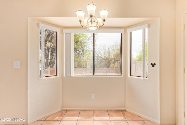 4755 W Lessing Ln, Tucson, AZ 85742 - unfurnished dining area with baseboards, a chandelier, and light tile patterned flooring