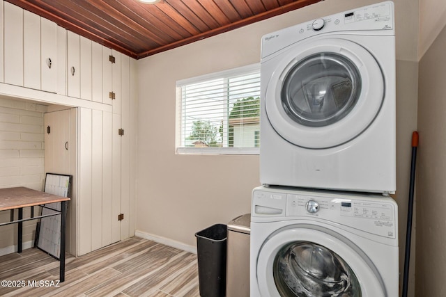1239 N Beverly Ave, Tucson, AZ 85712 - laundry area with stacked washer / dryer, baseboards, wood ceiling, light wood-style floors, and cabinet space