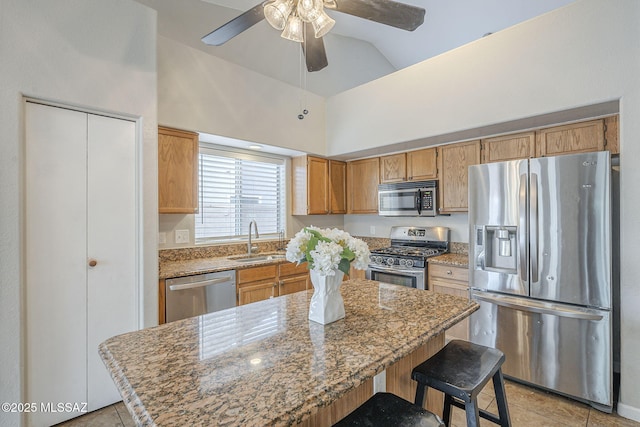 kitchen featuring light tile patterned floors, a ceiling fan, high vaulted ceiling, a sink, and stainless steel appliances
