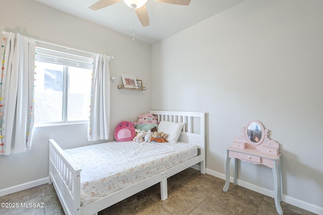 tiled bedroom featuring baseboards and ceiling fan