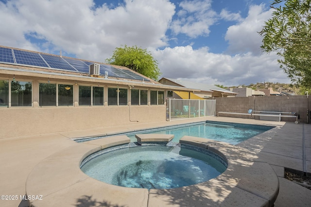 view of pool featuring a fenced backyard, a patio area, and a pool with connected hot tub