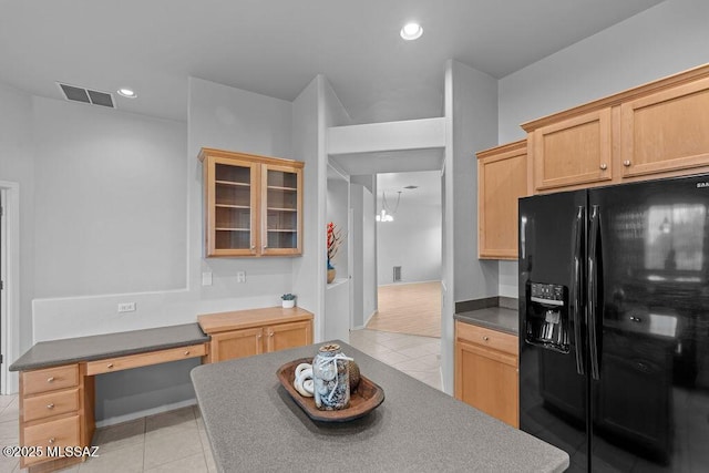 kitchen with black refrigerator with ice dispenser, light tile patterned floors, dark countertops, glass insert cabinets, and recessed lighting