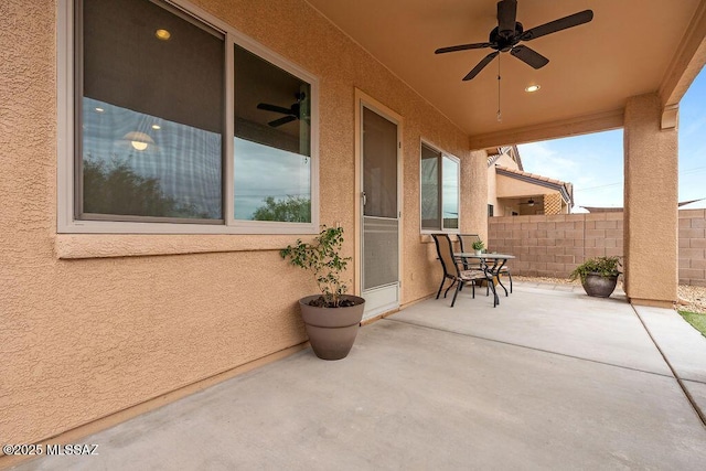 view of patio / terrace featuring ceiling fan and fence