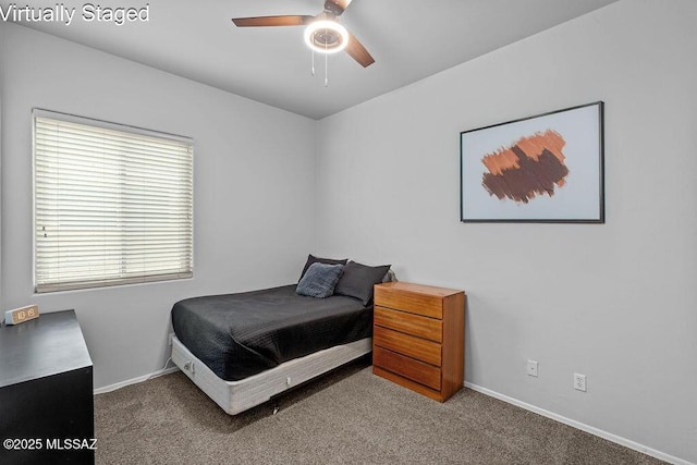 carpeted bedroom with baseboards and a ceiling fan